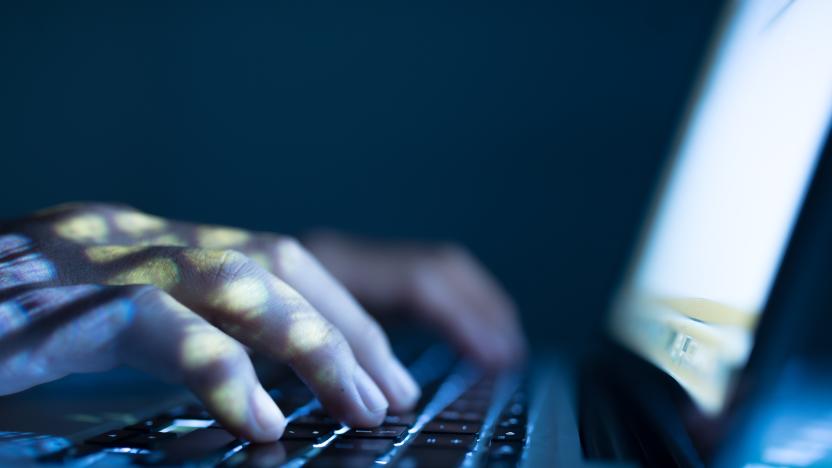 Close-up image of software engineer typing on laptop