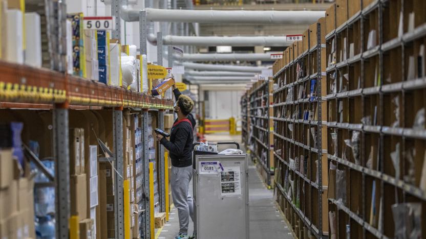 BRIESELANG, GERMANY - NOVEMBER 18: A worker selects ordered item among shelves at an Amazon warehouse on November 18, 2021 in Brieselang, Germany. Many shoppers who fear gifts will be lacking due to the global supply chain disruption are buying their Christmas gifts early this year, both online and at brick and mortar retailers. (Photo by Maja Hitij/Getty Images)