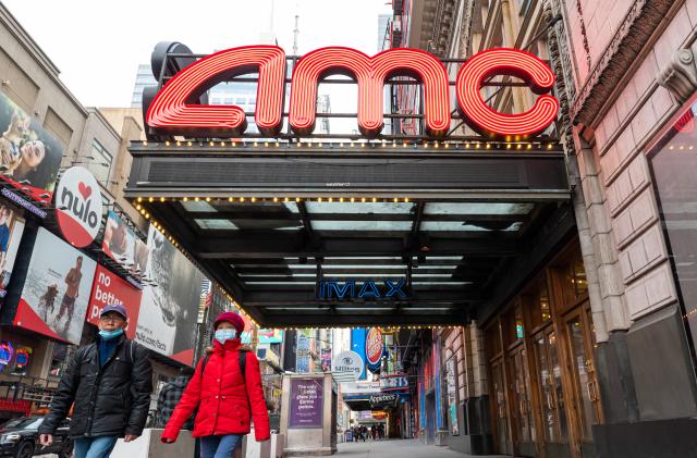 NEW YORK, NEW YORK - DECEMBER 23: People walk outside the AMC Empire 25 movie theater in Times Square as the city continues the re-opening efforts following restrictions imposed to slow the spread of coronavirus on December 23, 2020 in New York City. The pandemic has caused long-term repercussions throughout the tourism and entertainment industries, including temporary and permanent closures of historic and iconic venues, costing the city and businesses billions in revenue. (Photo by Noam Galai/Getty Images)