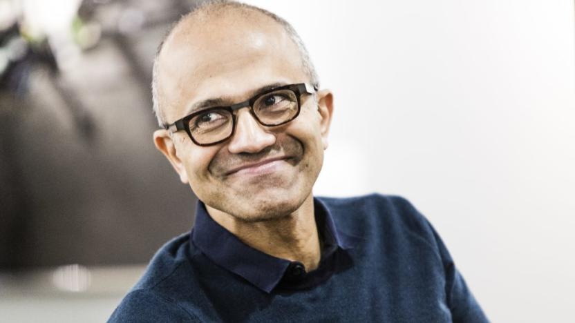 Photo of Microsoft CEO Satya Nadella looking to his right and grinning knowingly.