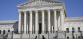 People view the Supreme Court building from behind security fencing. (AP)