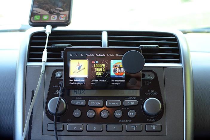 Photo of the Spotify Car Thing, a dash-mounted device with a four-inch screen and dial.