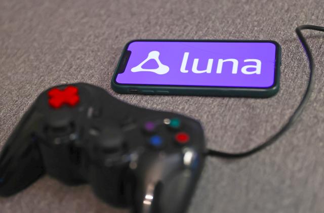 Luna logo displayed on a phone screen and a gamepad are seen in this illustration photo taken in Krakow, Poland on September 29, 2022. (Photo by )