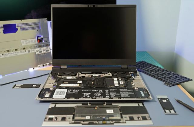 A Framework Laptop 16 laptop is shown open with its internals exposed and displayed in or around its casing.