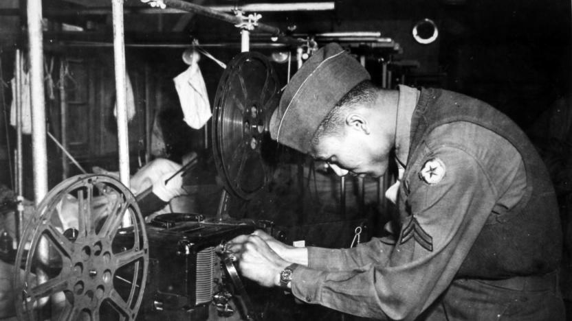 During World War 2, African American soldier Claybourne Miller of the 22nd General Hospital prepares a projector to show a movie to convalescing battle casualties, May 30, 1945. (Photo by Afro American Newspapers/Gado/Getty Images)