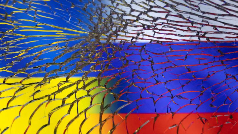 Ukraine and Russian flags are seen through broken glass in this illustration taken March 1, 2022. REUTERS/Dado Ruvic/Illustration