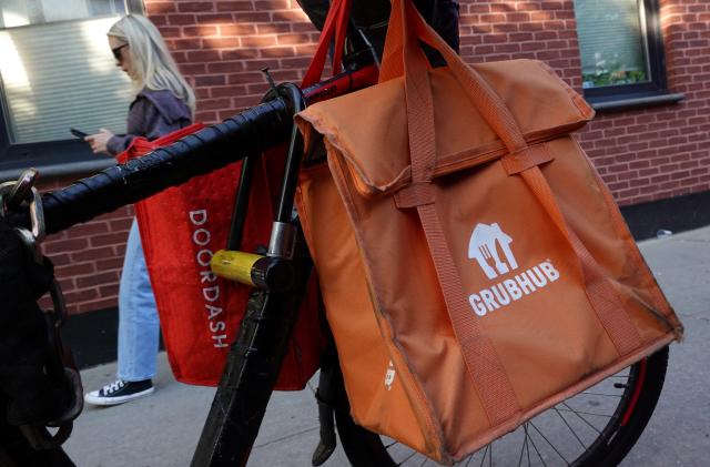 Doordash and Grubhub delivery bags are seen on a bicycle in Brooklyn, New York City, U.S., May 9, 2022. REUTERS/Andrew Kelly