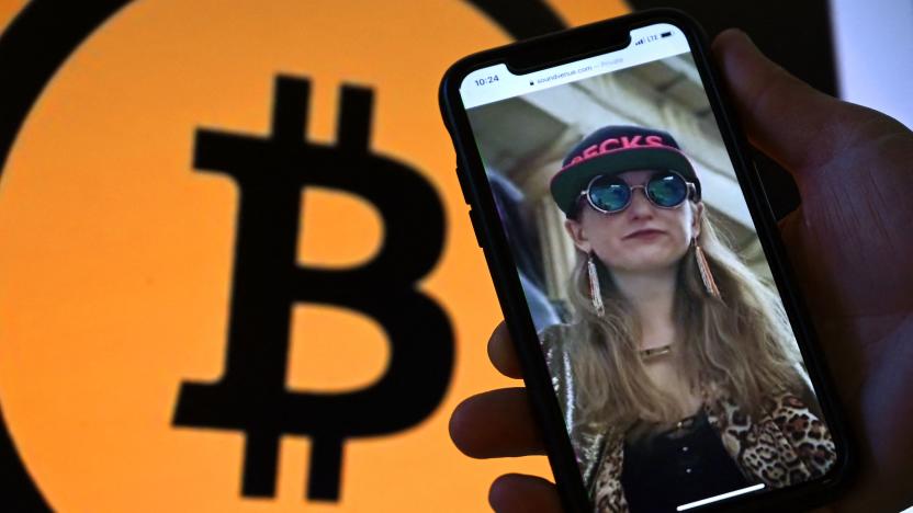 This illustration photo shows Heather Morgan, also known as "Razzlekhan," on a phone in front of the Bitcoin logo displayed on a screen, in Washington, DC, February 9, 2022. - A couple accused of seeking to launder the bitcoin were arrested in New York, the department said. Ilya Lichtenstein, 34, and his wife Heather Morgan, 31, were set to appear in federal court over the charges later in the day. (Photo by Olivier DOULIERY / AFP) (Photo by OLIVIER DOULIERY/AFP via Getty Images)