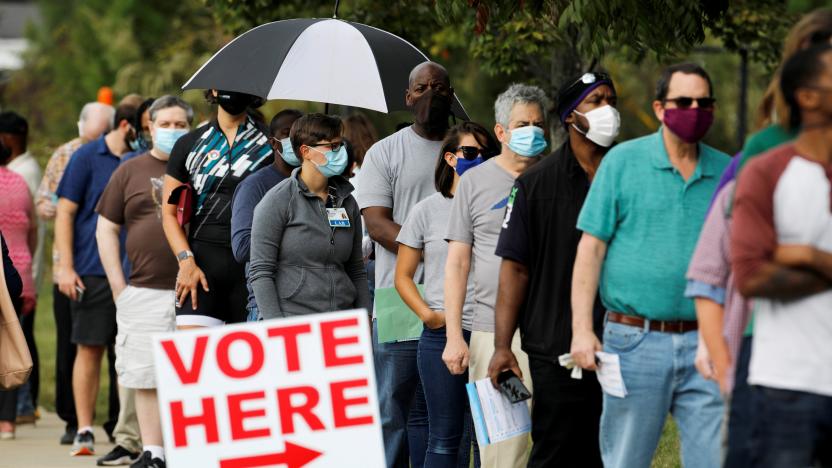 Voters wait in line to enter a polling place and cast their ballots on the first day of the state's in-person early voting for the general elections in Durham, North Carolina, U.S. October 15, 2020.    REUTERS/Jonathan Drake     TPX IMAGES OF THE DAY