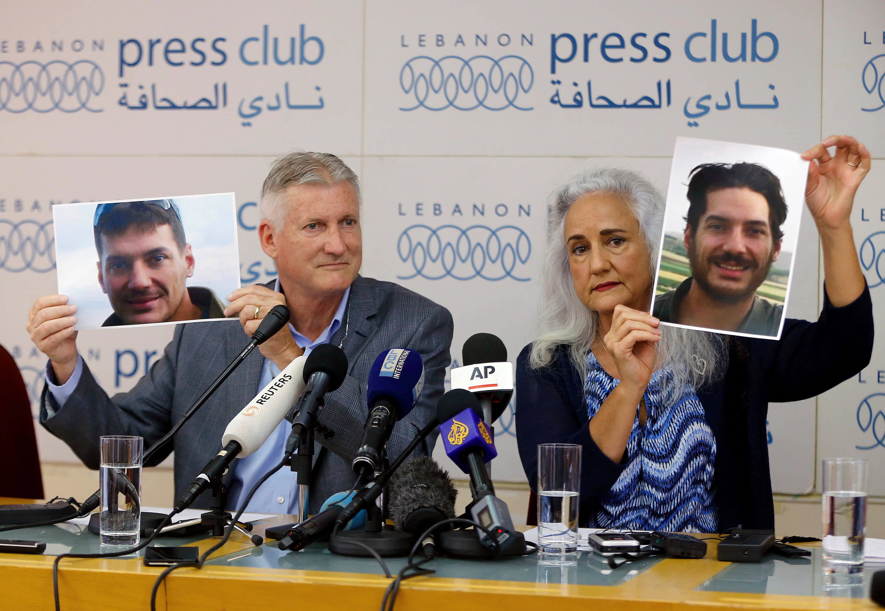 FILE - In this July 20, 2017, file photo, Marc and Debra Tice, the parents of Austin Tice, who has been missing in Syria since August 2012, hold up photos of him during a new conference, at the Press Club, in Beirut, Lebanon. A top Lebanese security official, Maj. Gen. Abbas Ibrahim said Saturday, Nov. 14, 2020, that after returning from Washington recently he visited Syria for two days where he spoke with officials about American journalist Austin Tice who has been missing in the war-torn country since 2012. (AP Photo/Bilal Hussein, File)