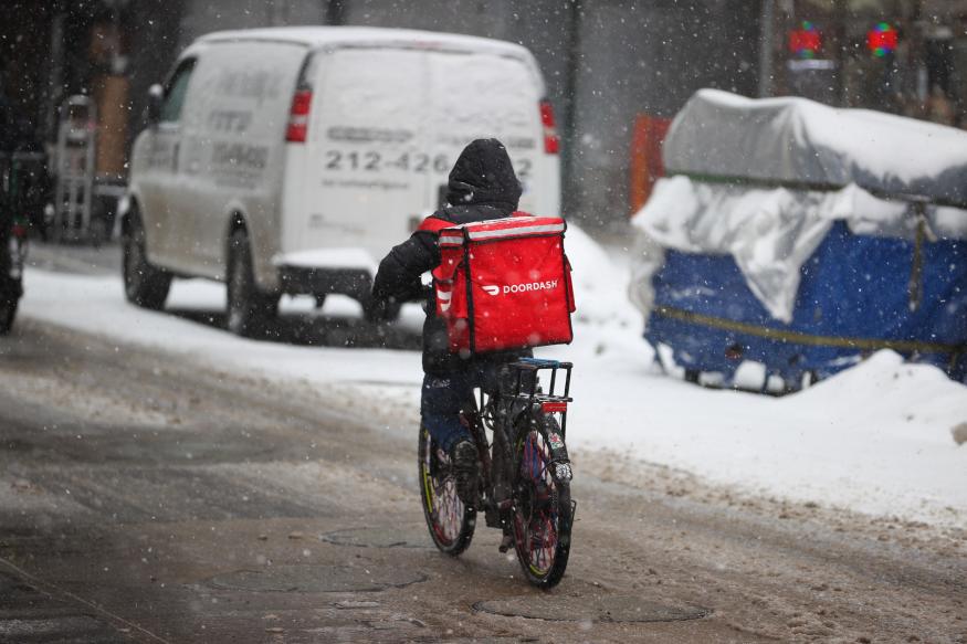 NEW YORK, USA - FEBRUARY 18: A food delivery guy with bicycle is seen as snowfall blankets the Times Square in New York City, United States as massive snow storm hits the east coast on February 18, 2021. (Photo by Tayfun Coskun/Anadolu Agency via Getty Images)