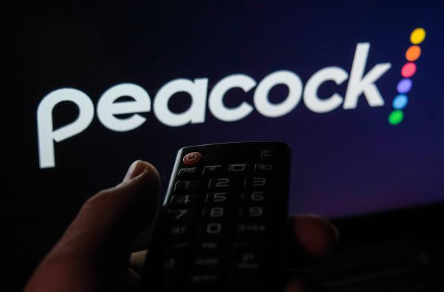 TV remote control is seen with Peacock logo displayed on a screen in this illustration photo taken in Krakow, Poland on February 6, 2022. (Photo by Jakub Porzycki/NurPhoto via Getty Images)