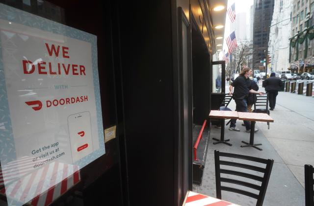 A DoorDash sign is pictured on a restaurant on the day they hold their IPO in the Manhattan borough of New York City, New York, U.S., December 9, 2020. REUTERS/Carlo Allegri