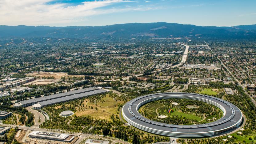 An aerial view of Apple Park headquarters in Cupertino CA showing the circle and the solar powered parking structure.  The solar panels installed on the roof of the campus can generate 17 megawatts of power, sufficient to power 75% during peak daytime, and making it one of the biggest solar roofs in the world.