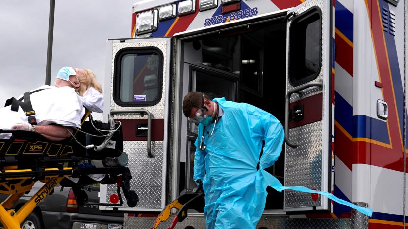 REACT EMS paramedics wearing protective gear load a potential coronavirus disease (COVID-19) patient for transport in Shawnee, Oklahoma, U.S. April 2, 2020. REUTERS/Nick Oxford     TPX IMAGES OF THE DAY