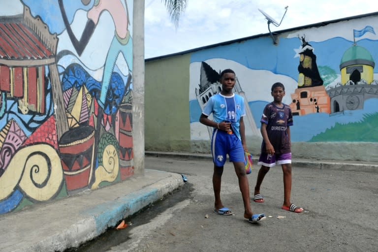 Children walk along a street of the Nigeria neighborhood in Guayaquil, Ecuador, a port city where hundreds of people have died of COVID-19 (AFP Photo/Jose Sanchez LINDAO)