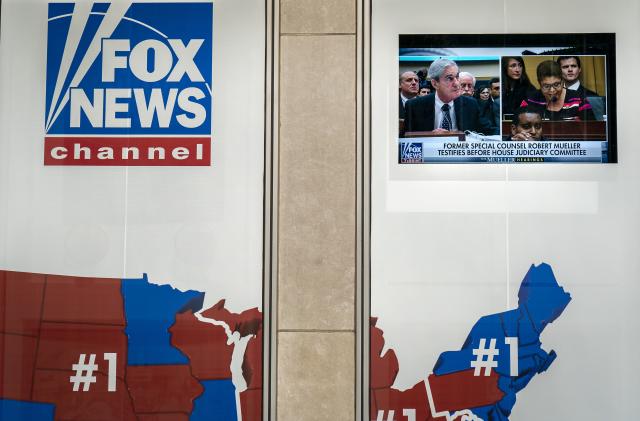 NEW YORK, NY - JULY 24: Former Special Counsel Robert Mueller's testimony to Congress is shown on a screen outside of the Fox News headquarters on July 24, 2019 in New York City. Mueller is testifying before the House Judiciary Committee and House Intelligence Committee in back-to-back hearings on Capitol Hill. (Photo by Drew Angerer/Getty Images)