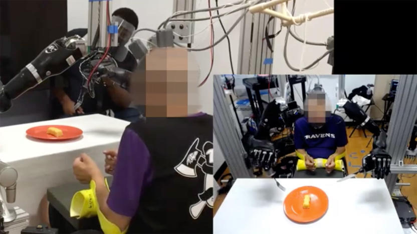 Robotic arms help a man with paralysis feed himself