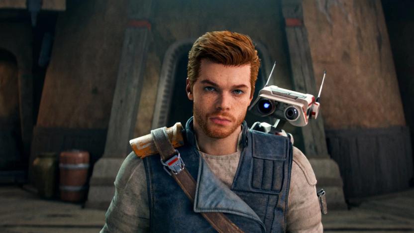 Cal Kestis, the protagonist of Star Wars Jedi: Survivor, with BD-1, his droid companion, against the backdrop of a tan building.  