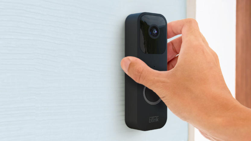 The Blink video doorbell is being installed wirelessly on a house to the side of the front door.  