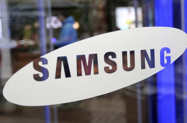 A man walks by the entrance to Samsung Electronics Co.'s showroom at its headquarters in Seoul, South Korea, Friday, July 6, 2012. Samsung, the world's largest maker of memory chips, mobile phones, flat-screen panels and televisions, said Friday that its preliminary second-quarter operating profit jumped nearly 80 percent from a year ago to a record high. (AP Photo/Hye Soo Nah)