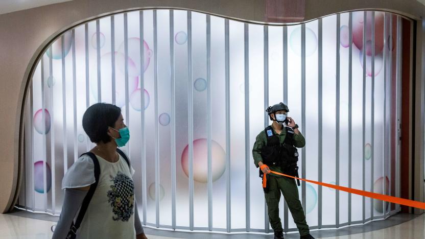 A riot police officer stands guard after a protest by district councillors at a mall in Yuen Long in Hong Kong on July 19, 2020, against a mob attack by suspected triad gang members inside the Yuen Long train station on July 21, 2019. (Photo by ISAAC LAWRENCE / AFP) (Photo by ISAAC LAWRENCE/AFP via Getty Images)