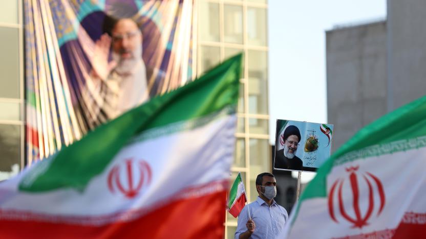 A supporter of presidential candidate Ebrahim Raisi holds a poster of him during an election rally in Tehran, Iran June 14, 2021. Majid Asgaripour/WANA (West Asia News Agency) via REUTERS ATTENTION EDITORS - THIS IMAGE HAS BEEN SUPPLIED BY A THIRD PARTY. ATTENTION EDITORS - THIS PICTURE WAS PROVIDED BY A THIRD PARTY