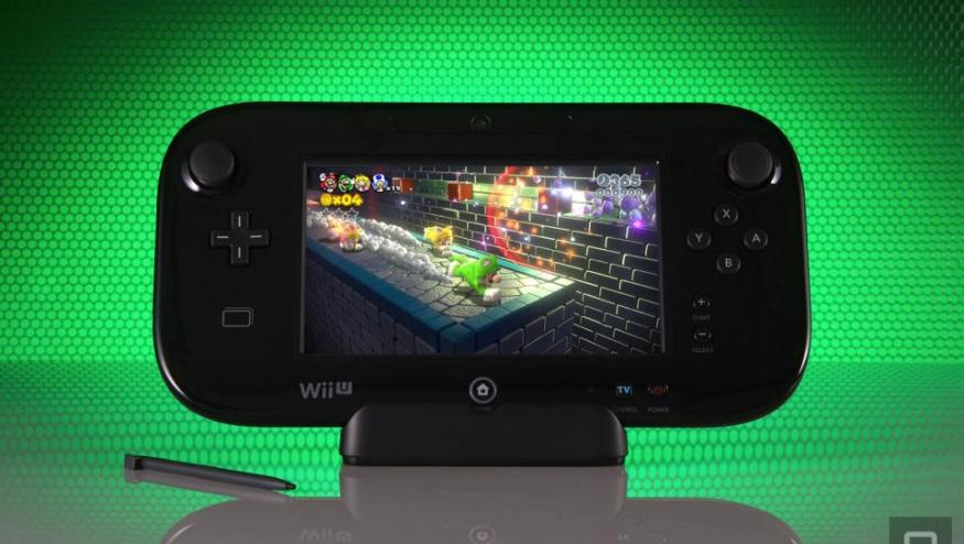 The Wii U gamepad propped up in front of a green honeycomb-style background. Its stylus sits next to it, and it has a prominent reflection below.