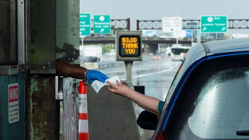 A driver pays his toll at the start of the Memorial Day weekend, under rising gas prices and record inflation, in Elizabeth, New Jersey, U.S., May 27, 2022.  REUTERS/Eduardo Munoz