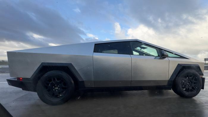 A Tesla Cybertruck is shown being driven along a freeway in Oceanside, California, U.S., February 7, 2024. REUTERS/Mike Blake