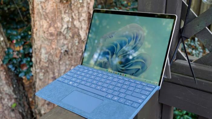 A laptop on a wood slab. 