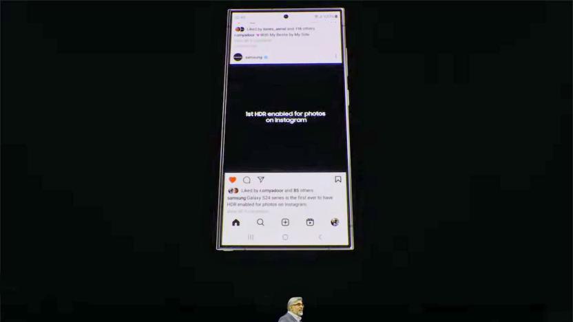 A Samsung Galaxy S24 displays an Instagram feed entry stating it's the "...first HDR enabled for photos on Instagram" on a large screen above a presenter's head at Samsung's Unpacked 2024 event.