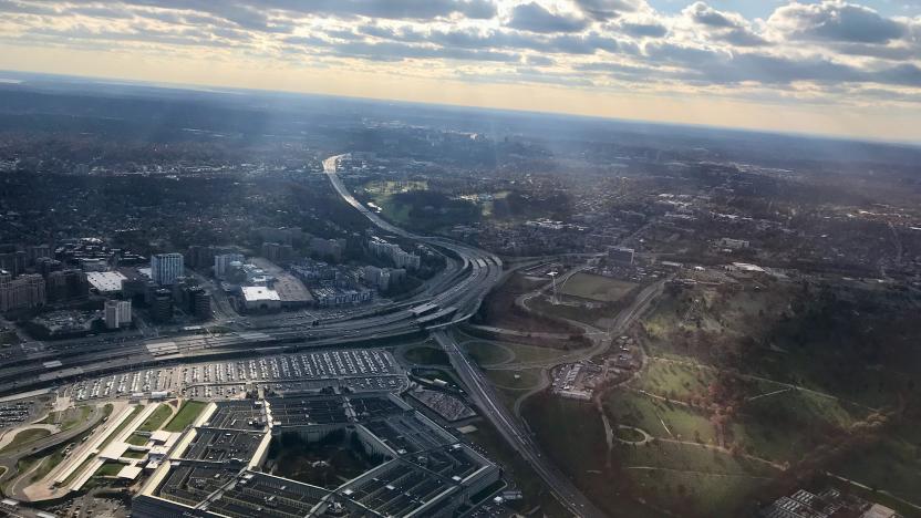 An aerial view of the Pentagon with clouds partially blocking the sun providing visible columns of light.