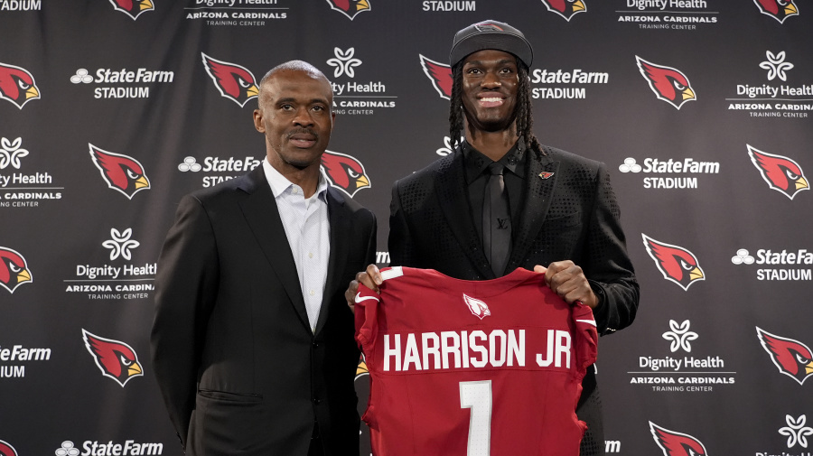 Associated Press - Arizona Cardinals first round draft pick Marvin Harrison Jr, right, stands with his dad, Marvin Harrison Sr. at an NFL football press conference, Friday, April 26, 2024, at the teams' facility in Tempe, Ariz. (AP Photo/Matt York)