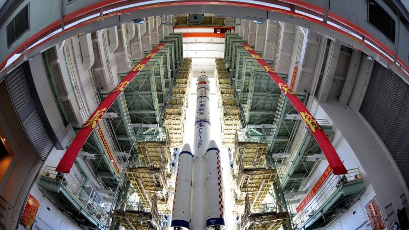 The Shenzhou-9 manned spacecraft, Long March-2F rocket, and escape tower wait to be transferred to the launch pad at the Jiuquan Satellite Launch Center, Gansu province June 9, 2012. China will launch its Shenzhou-9 manned spacecraft sometime in mid-June to perform the country's first manned space docking mission with the orbiting Tiangong-1 space lab module, a spokesperson with the country's manned space program said here Saturday, Xinhua News Agency reported. REUTERS/China Daily  (CHINA - Tags: SCIENCE TECHNOLOGY TPX IMAGES OF THE DAY) CHINA OUT. NO COMMERCIAL OR EDITORIAL SALES IN CHINA