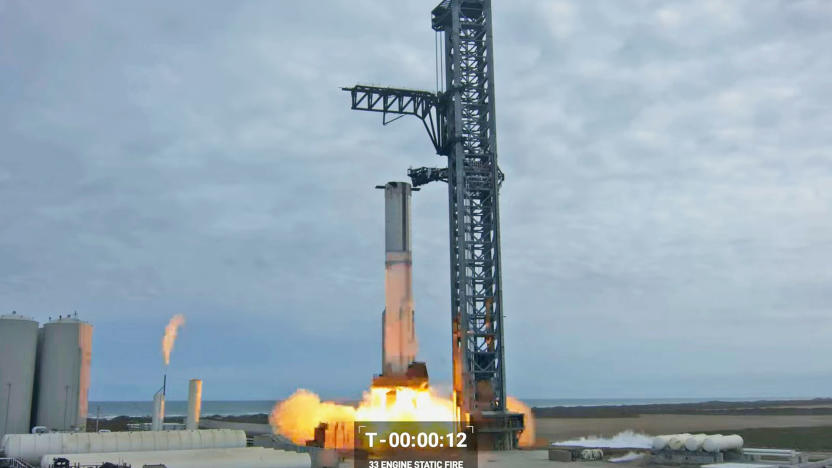 A still image from YouTube of the SpaceX Starship first full static fire test, showing the rocket firing while still attached to its support tower.