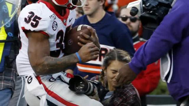 Photographer knocked out on sideline after scary collision