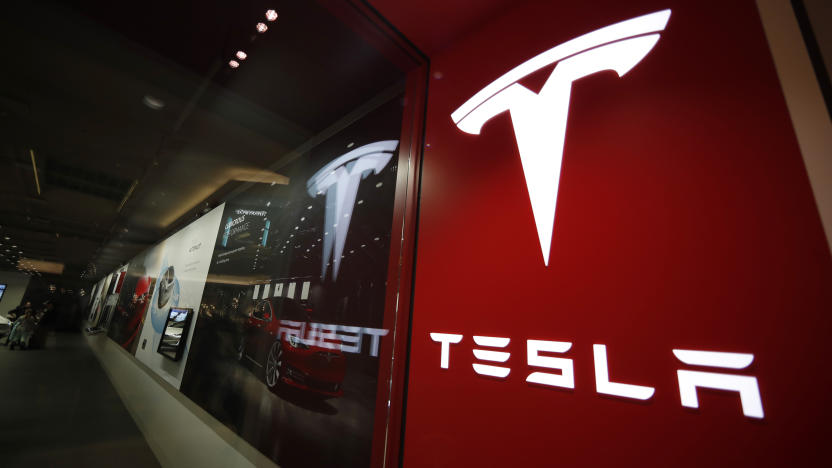 FILE - A sign bearing the company logo outside a Tesla store in Cherry Creek Mall in Denver is seen here on Feb. 9, 2019. Tesla is recalling nearly 363,000 vehicles with its “Full Self-Driving” system to fix problems with the way it behaves around intersections and following posted speed limits, the National Highway Traffic Safety Administration announced Thursday, Feb. 16, 2023. (AP Photo/David Zalubowski, File)