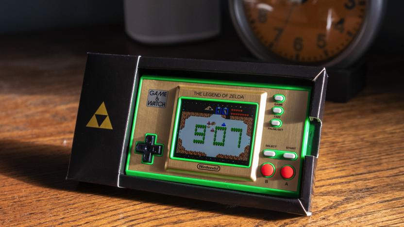 The rectangular Zelda Game & Watch sitting on an old wooden desktop.