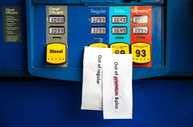 Notes are left on gas pumps to let motorists know the pumps are empty at an Exxon gas station in Charlotte, North Carolina on May 12, 2021. - Fears the shutdown of the Colonial Pipeline because of a cyberattack would cause a gasoline shortage led to some panic buying and prompted US regulators on May 11, 2021 to temporarily suspend clean fuel requirements in three eastern states and the nation's capital. (Photo by Logan Cyrus / AFP) (Photo by LOGAN CYRUS/AFP via Getty Images)