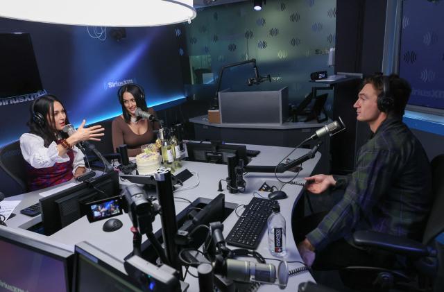 NEW YORK, NEW YORK - NOVEMBER 18: Brie Bella (L) and Nikki Bella speak to guest Tyler Cameron as they host SiriusXM Stitcher's The Bellas Podcast at SiriusXM Studios on November 18, 2021 in New York City. (Photo by Mike Coppola/Getty Images for SiriusXM)