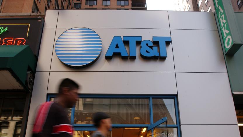 391649 04: People walk past an AT&T Wireless store July 9, 2001 in New York City. The cable company Comcast has made a bid to merge with AT&T broadband. The combination of the two corporations would create the largest broadband communications provider in the world, with approximately 22 million subscribers. (Photo by Spencer Platt/Getty Images)