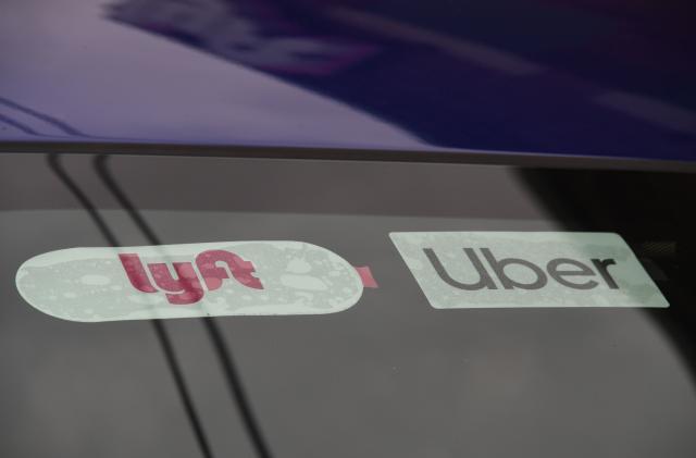 Rideshare drivers demonstrate against rideshare companies Uber and Lyft during a car caravan protest on August 6, 2020 in Los Angeles. - The drivers, organized by the Mobile Workers Alliance and Rideshare Drivers United unions, say Uber and Lyft's are pushing a "deceptive" November ballot initiative, which, if passed, they claim would "rewrite labor law" and turn app-based drivers into independent contractors, exempting companies such as Lyft and Uber from standard wage and hour restrictions. (Photo by Robyn Beck / AFP) (Photo by ROBYN BECK/AFP via Getty Images)