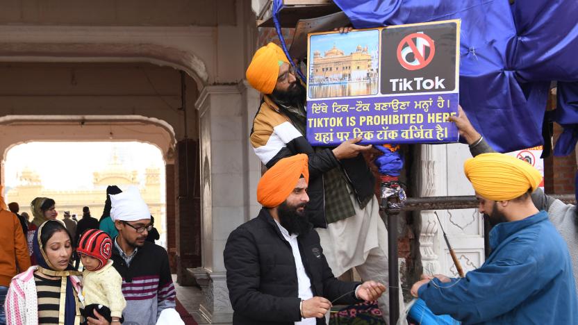 Sikh volunteers hangs a board reading 'Tiktok is prohibited here' at the Golden Temple in Amritsar on February 10, 2020. (Photo by NARINDER NANU / AFP) (Photo by NARINDER NANU/AFP via Getty Images)