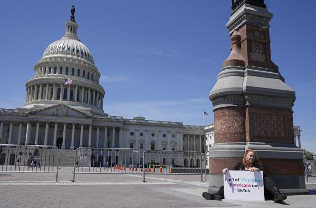 Jennifer Gay, a TikTok content creator, sits outside the U.S. Capitol, Tuesday, April 23, 2024, in Washington as Senators prepare to consider legislation that would force TikTok’s China-based parent company to sell the social media platform under the threat of a ban, a contentious move by U.S. lawmakers. (AP Photo/Mariam Zuhaib)