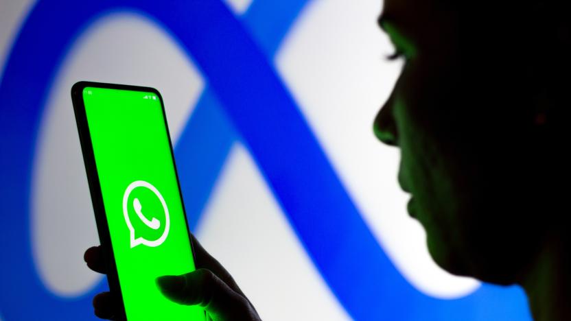 BRAZIL - 2022/03/16: In this photo illustration, a woman holds a smartphone with the WhatsApp logo displayed on the screen with the Meta Platforms logo displayed in the background. (Photo Illustration by Rafael Henrique/SOPA Images/LightRocket via Getty Images)