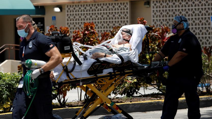 Emergency Medical Technicians (EMT) leave with a patient at Hialeah Hospital where the coronavirus disease (COVID-19) patients are treated, in Hialeah, Florida, U.S., July 29, 2020. REUTERS/Marco Bello     TPX IMAGES OF THE DAY