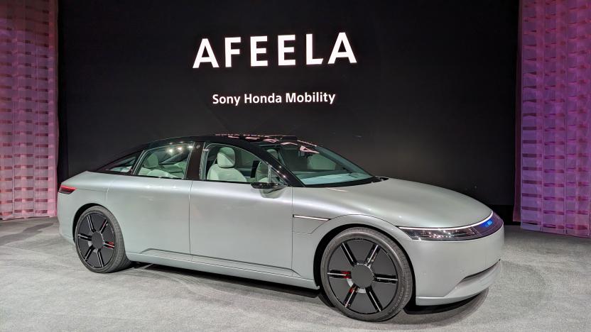 The Vision-S 02 electric SUV is now the Afeela, on display at CES 2023 on a low carpeted stage with the name in the background.