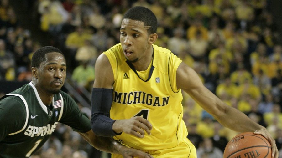 Associated Press - Michigan guard Darius Morris (4) is pressured by Michigan State guard Kalin Lucas (1) while bringing the ball up court in the second half of a NCAA college basketball game Saturday, March 5, 2011, in Ann Arbor, Mich. (AP Photo/Duane Burleson)