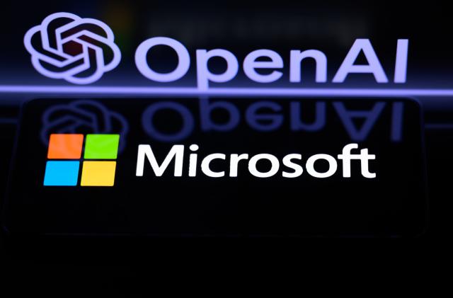 The Microsoft logo is being displayed on a smart phone, with the OpenAI logo visible on the screen in the background, in this photo illustration taken in Brussels, Belgium, on January 6, 2024. (Photo by Jonathan Raa/NurPhoto via Getty Images)